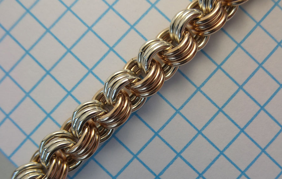 3-in-3 chainmaille chain in mixed metals on graph paper