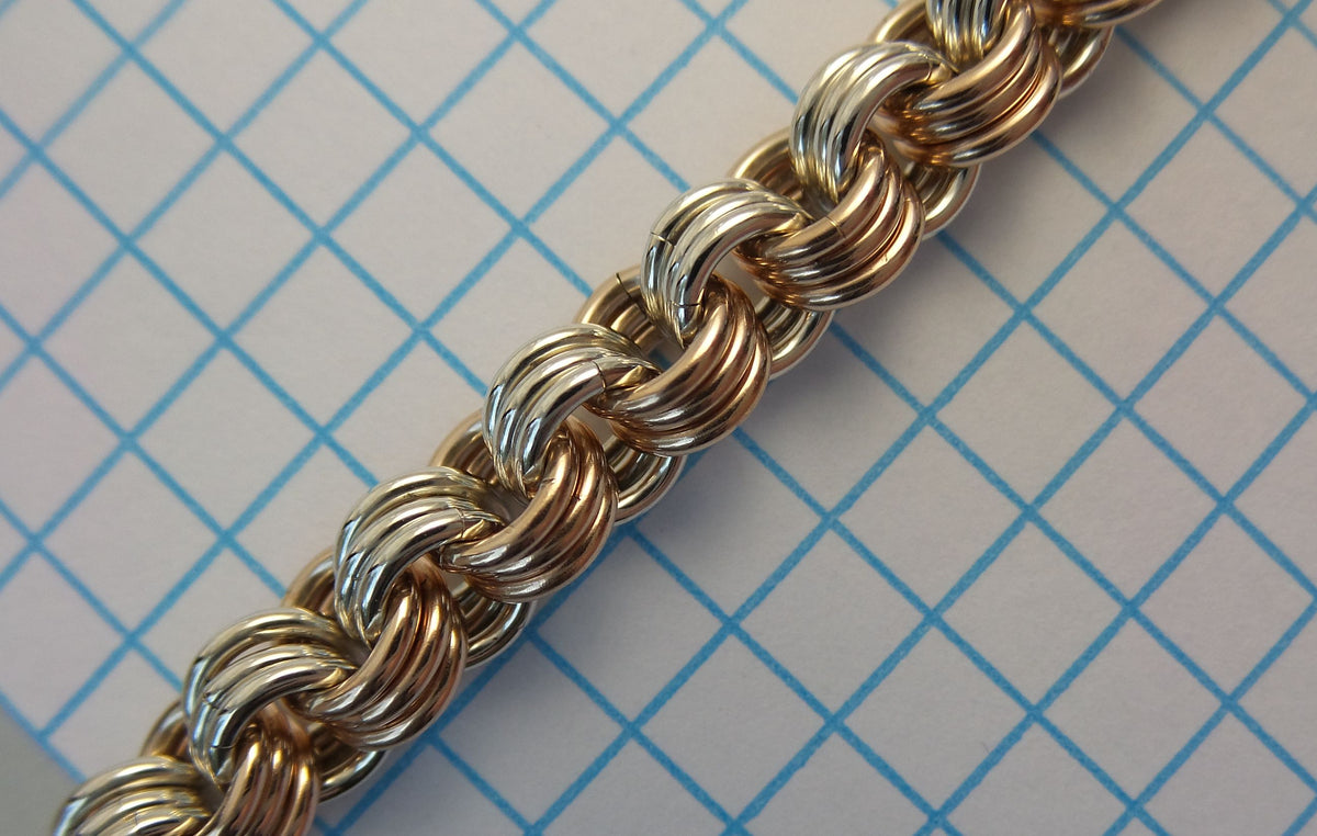 3-in-3 chainmaille chain in mixed metals on graph paper
