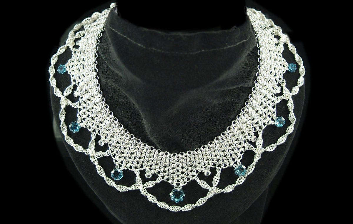 Camelot: sterling silver chainmaille collar necklace in graduated European 4-in-1 with single spiral draping chains and London Blue Topaz drops, on a black velvet bust, Urban Maille
