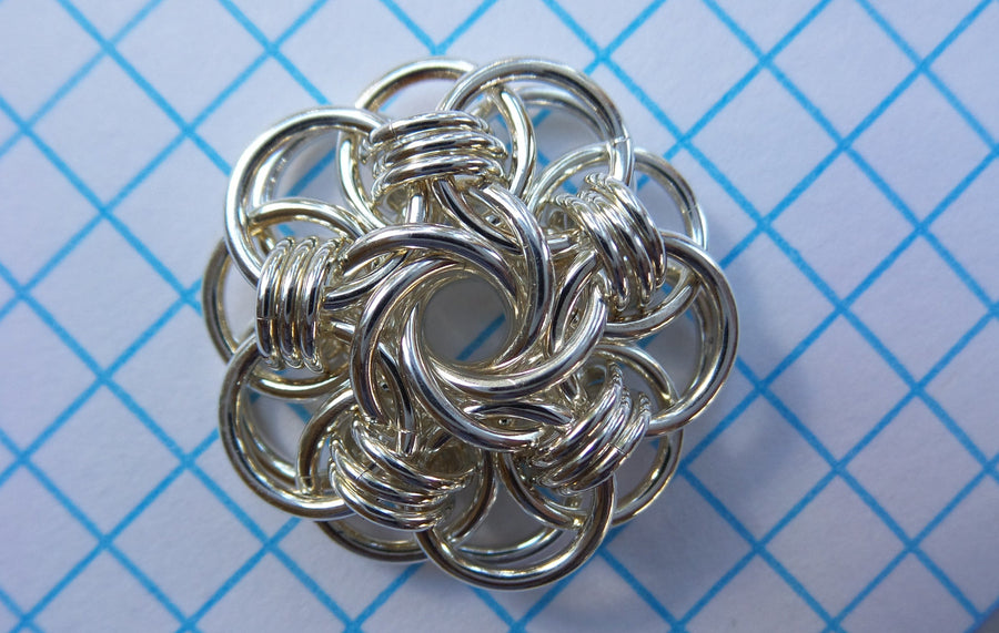 Vortex Medallion in sterling silver chainmaille on graph paper, Urban Maille