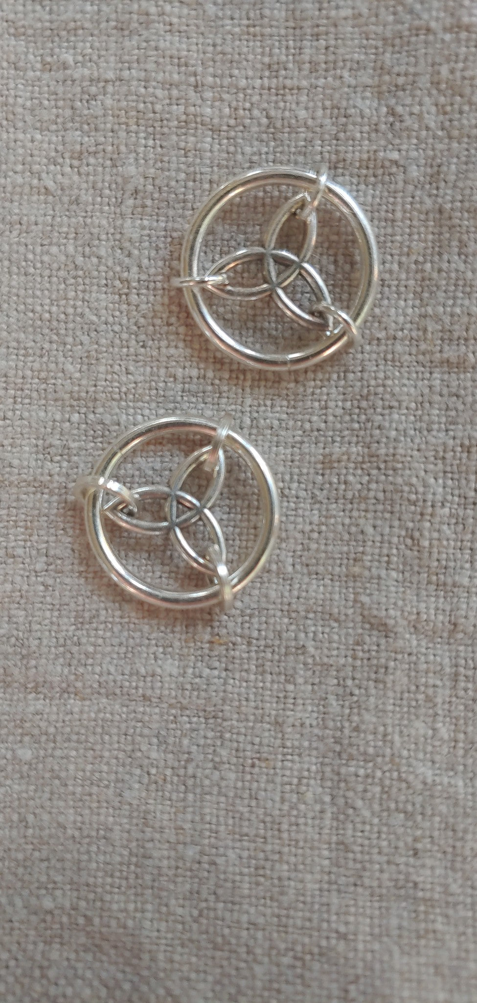 Celtic Triquetra charms on linen
