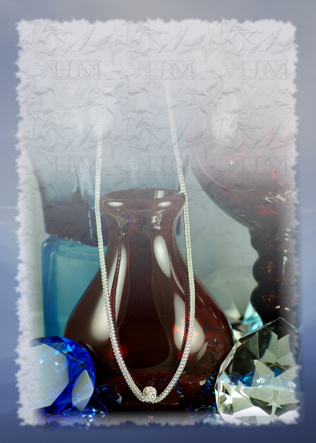 Serpentine necklace in sterling silver Half Persian 4-in-1 chainmaille draped over a red glass vase